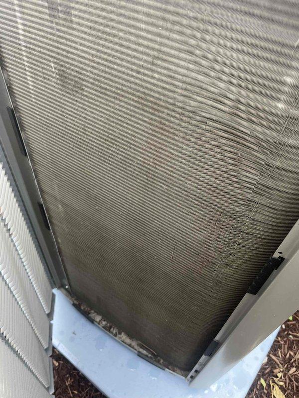 Completed comprehensive AC tune-up on outdoor condensing unit. Inspected heat exchanger coils which showed significant dirt and debris accumulation, particularly in lower sections and between aluminum fins. Performed standard preventive maintenance procedures including system performance evaluation and visual inspection of all accessible components. Unit operational upon completion of service.