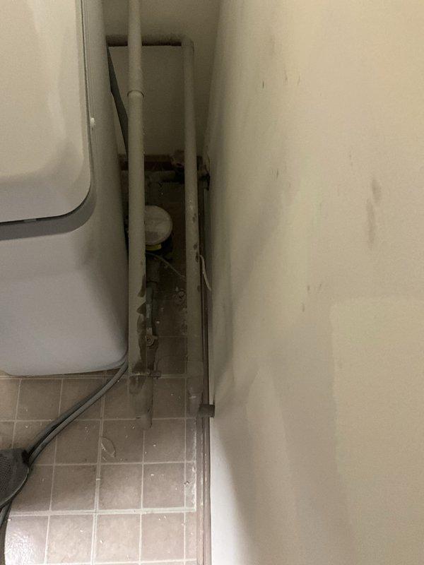 Responded to residential service call to temporarily disconnect and remove Rheem Performance tanked water heater and water softener system to facilitate flooring renovation work. Shut off water supply via ball valves, disconnected copper supply lines and pressure relief valve assembly, and detached galvanized metal vent piping at elbow connection. Safely removed both water heater unit and water softener from utility space, capping all plumbing connections to prevent water damage during construction. Equipment will be reinstalled upon completion of flooring installation.