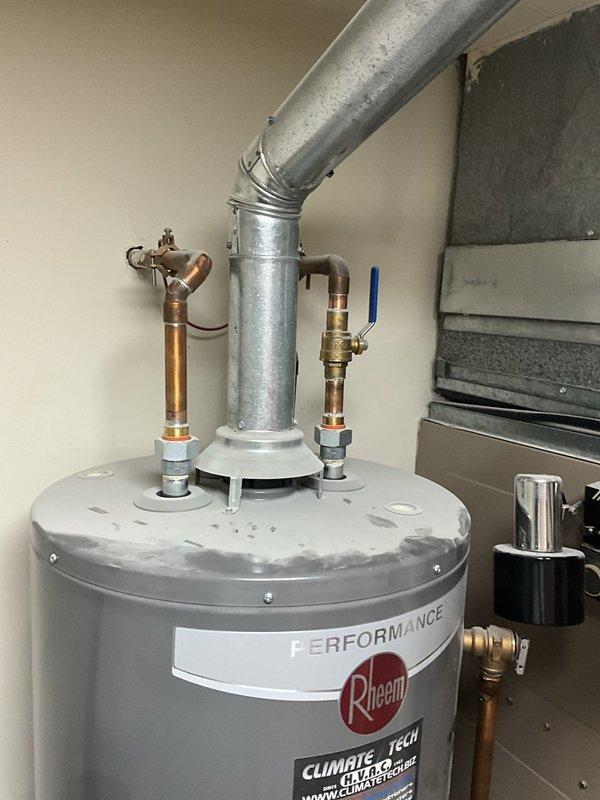 Responded to residential service call to temporarily disconnect and remove Rheem Performance tanked water heater and water softener system to facilitate flooring renovation work. Shut off water supply via ball valves, disconnected copper supply lines and pressure relief valve assembly, and detached galvanized metal vent piping at elbow connection. Safely removed both water heater unit and water softener from utility space, capping all plumbing connections to prevent water damage during construction. Equipment will be reinstalled upon completion of flooring installation.