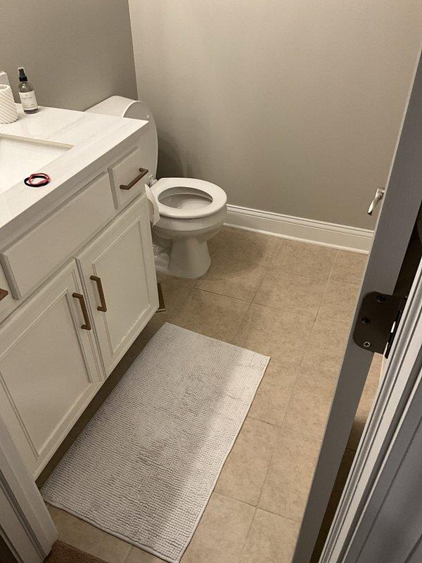 Responded to service call for non-functioning toilet in basement bathroom. Upon arrival, homeowner had already procured replacement toilet unit in preparation for weekend guests. Removed existing two-piece toilet fixture, including disconnection of water supply line and removal of floor flange bolts. Cleaned and inspected toilet flange for damage or deterioration to ensure proper seal. Installed new white porcelain two-piece toilet with standard tank-style configuration, securing unit to floor flange with new mounting hardware. Connected water supply line to fill valve and tested for leaks. Verified proper flush operation, tank refill function, and water shut-off valve operation. Confirmed no water leakage at base seal or supply connection points. Left work area clean with all fixtures operational and ready for immediate use.