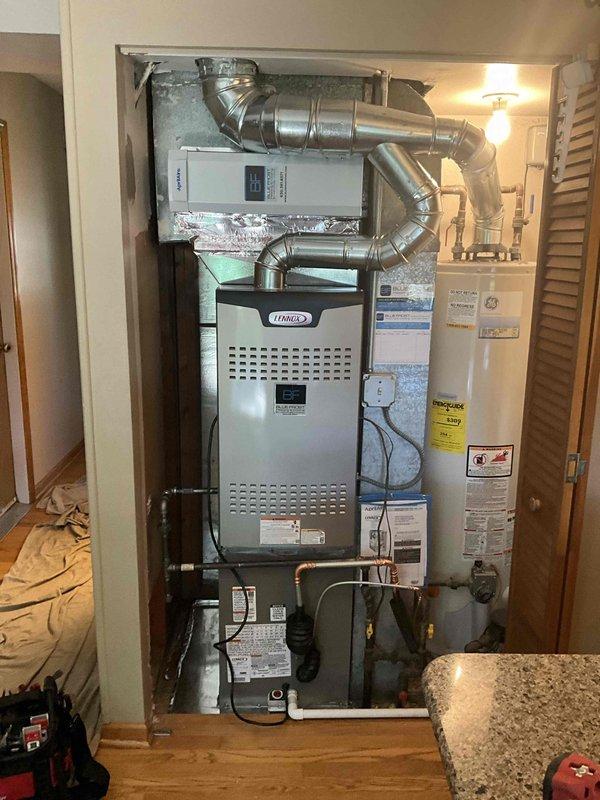 Completed full HVAC system installation in residential bedroom closet space, including Lennox SL280DF090V48BK downflow gas furnace (90,000 BTU), EL15KC1-036-230 air conditioning condenser (3-ton, 15 SEER), and CK40DT-30/36B-71 evaporator coil. Installed all supply and return ductwork with proper insulation, configured downflow setup to accommodate existing closet configuration adjacent to water heater. Ran refrigerant lines between indoor and outdoor units, evacuated system, and charged to manufacturer specifications. Installed P200 thermostat and AA1410 accessories. Completed all electrical connections, tested furnace ignition sequence and heat output, verified airflow across evaporator coil, and confirmed proper condensate drainage. System commissioned successfully with all safety controls operational and performance parameters meeting Lennox specifications.