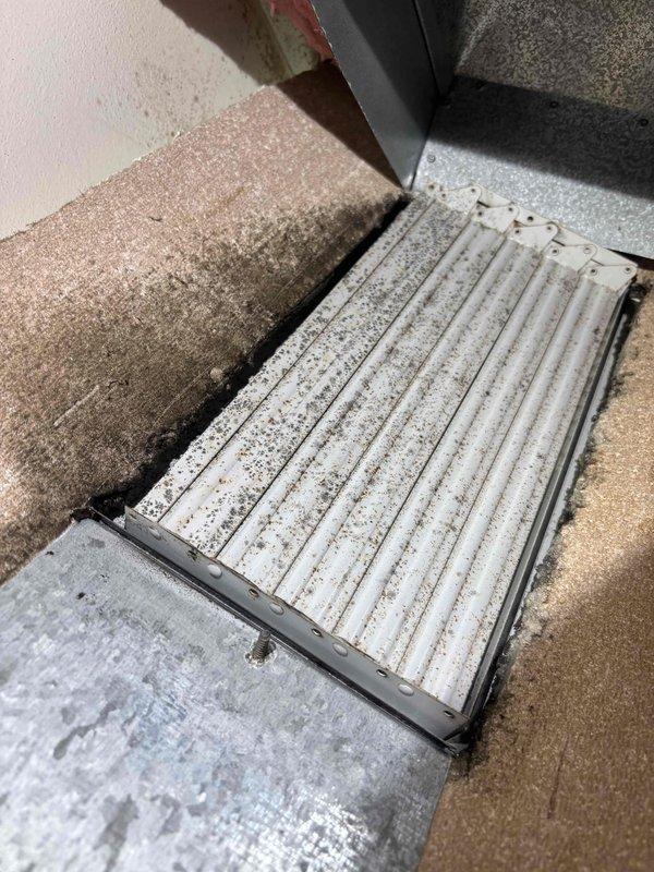 Responded to commercial air conditioning service call for disconnected ductwork on unit C. Upon arrival, inspected the affected area and confirmed that supply ductwork had separated and fallen from its mounting position. Assessed the floor register and traced the ductwork back to the point of failure between floor joists. Verified that the insulated ductwork had detached from its hangers, causing the insulation to pull away from the metal duct seams. Reinstalled and secured the fallen ductwork section, ensuring proper alignment and connection integrity. Reattached insulation batting and verified all duct connections were sealed. Confirmed airflow was restored to the affected zone and that the system maintained proper cooling operation throughout the building. Unit returned to normal service with no further issues observed.