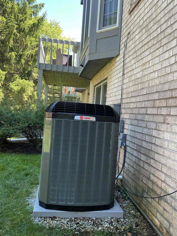 Completed comprehensive BFMA tune-up service on a Trane air conditioning system over 2 years old. Performed full system inspection including electrical connections in outdoor disconnect box, verified proper wiring and relay operation, and inspected condenser unit coils and components. System tested and found operating within manufacturer specifications with no issues identified during maintenance visit.
