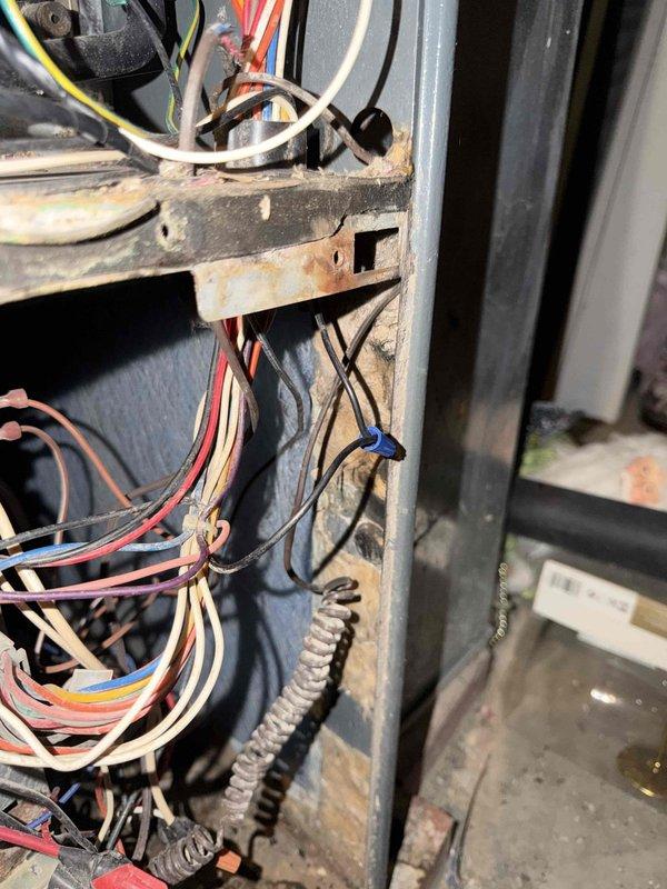 Responded to no-cooling complaint and performed diagnostic evaluation of air conditioning system. Upon inspection, discovered failed capacitor with visible burn damage and deterioration. Found significant corrosion and rust on electrical panel components and mounting brackets, indicating prolonged moisture exposure. Replaced defective capacitor and verified proper electrical connections throughout control box. System restored to normal operation with proper cooling functionality confirmed.