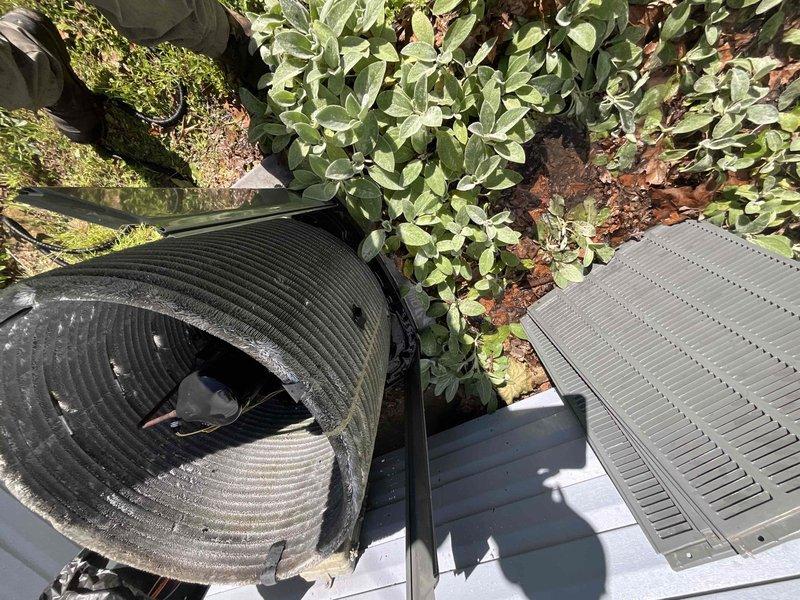 Completed comprehensive BFMA tune-up and air conditioning maintenance on outdoor condensing unit. Performed full system inspection including electrical component testing with multimeter to verify proper voltage and capacitance readings. Inspected capacitor condition and all wire connections, confirming secure terminations with wire nuts at control board and component connections. Evaluated condenser coil fins for proper airflow and assessed flexible ductwork condition, noting deterioration and wear on exterior duct material that may require future attention. Verified unit operation and electrical safety. System is operational and ready for cooling season.