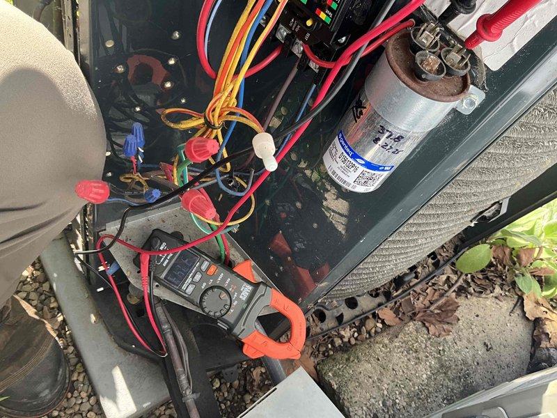 Completed comprehensive BFMA tune-up and air conditioning maintenance on outdoor condensing unit. Performed full system inspection including electrical component testing with multimeter to verify proper voltage and capacitance readings. Inspected capacitor condition and all wire connections, confirming secure terminations with wire nuts at control board and component connections. Evaluated condenser coil fins for proper airflow and assessed flexible ductwork condition, noting deterioration and wear on exterior duct material that may require future attention. Verified unit operation and electrical safety. System is operational and ready for cooling season.