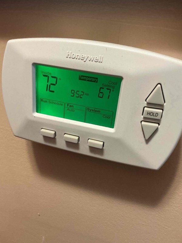 Completed comprehensive BFMA tune-up service on residential air conditioning system over 3 years old. Performed standard maintenance protocol including inspection of Emerson control board and wiring connections, verified proper operation of Honeywell digital thermostat displaying 72°F ambient with cooling setpoint at 67°F, and documented system components through photographic records. All electrical connections, control circuits, and thermostat functions tested and confirmed operational with system running in cooling mode.