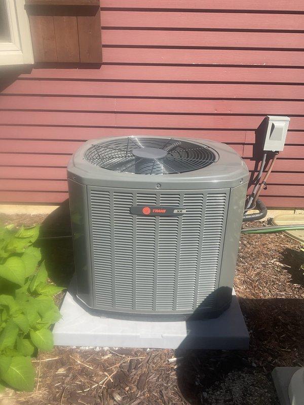 Completed comprehensive BFMA tune-up service on a Trane outdoor condensing unit approximately 2+ years old. Performed full system inspection including cleaning condenser coils, checking refrigerant levels, testing electrical connections at disconnect box, inspecting fan motor operation, verifying proper airflow through louvered panels, and confirming unit operation on concrete pad. All components found operating within manufacturer specifications with no immediate repairs required.