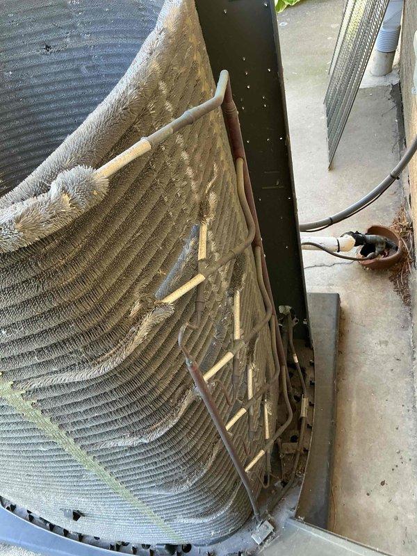 Completed comprehensive BFMA tune-up service on a 5+ year old Blue Frontier/Trane outdoor condensing unit. Upon inspection, discovered evaporator coils heavily clogged with dust, dirt, and debris accumulation that was significantly restricting airflow and reducing system efficiency. Thoroughly cleaned and cleared all coil fins, removed embedded debris, and restored proper airflow through the heat exchange surfaces to optimize cooling performance and prevent premature system failure.