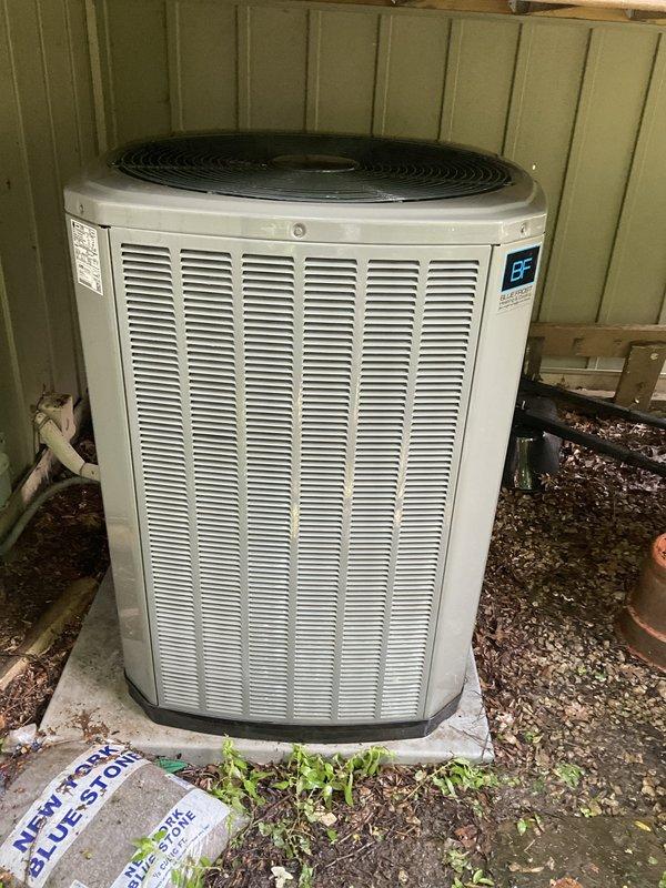 Completed BFMA tune-up service on a 5-year-old residential air conditioning system. Upon inspection, discovered significant ice and frost buildup on the evaporator coil assembly, indicating a potential refrigerant restriction, airflow issue, or low refrigerant charge. Documented the iced coil condition and outdoor condensing unit with photographs. The heavy frost accumulation on the upper portions of the coil fins and copper refrigerant lines suggests the system was experiencing reduced cooling capacity and efficiency. Inspected the outdoor condensing unit, which appeared in serviceable condition with proper installation on a concrete pad. The unit showed normal wear consistent with its age, with some debris accumulation noted. Recommended further diagnostic testing to determine the root cause of the freezing condition, which may require checking refrigerant levels, verifying proper airflow across the coil, inspecting the metering device, and evaluating the air filter and ductwork for 