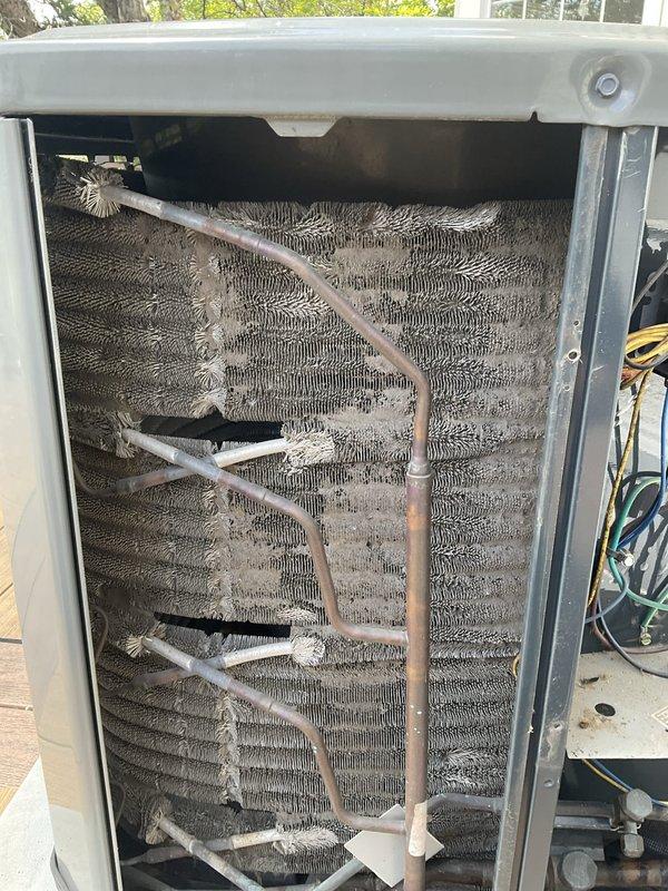 Completed comprehensive BFMA tune-up service on an 8-year-old air conditioning system. Performed thorough inspection of evaporator coil assembly, which showed significant accumulation of dirt and debris restricting airflow between aluminum fins. Inspected refrigerant lines including copper tubing with visible oxidation patina, verified secure mounting of all lines and connections, and examined electrical components. System was evaluated for operational efficiency, with coil condition documented showing need for cleaning to restore optimal airflow and performance.