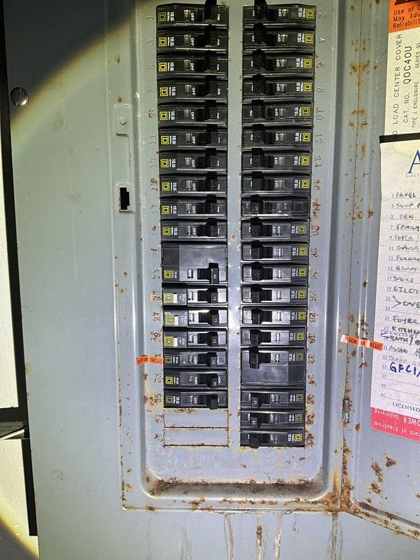 Performed site assessment for mini split installation in residential garage space. Evaluated existing garage layout, including ceiling-mounted door opener mechanism, available wall space, and electrical infrastructure. Documented current electrical panel configuration showing Square D breaker arrangement with visible corrosion on enclosure, indicating potential need for electrical upgrades to support new mini split system. Assessed optimal placement for indoor air handler unit and outdoor condenser, taking into account garage door clearances, ceiling obstructions, and access requirements. Provided estimate for ductless mini split system installation including equipment specifications, electrical requirements, and installation scope.