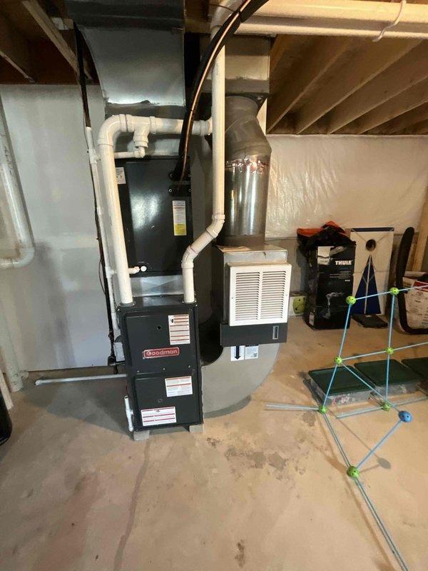Completed comprehensive BFMA tune-up service on a Goodman HVAC system over 2 years old, including both indoor furnace unit located in basement mechanical room and outdoor cylindrical air conditioning condenser. Performed standard maintenance procedures on both components, inspected all connections, PVC condensate lines, ductwork, and verified proper system operation to ensure optimal performance for the upcoming cooling season.