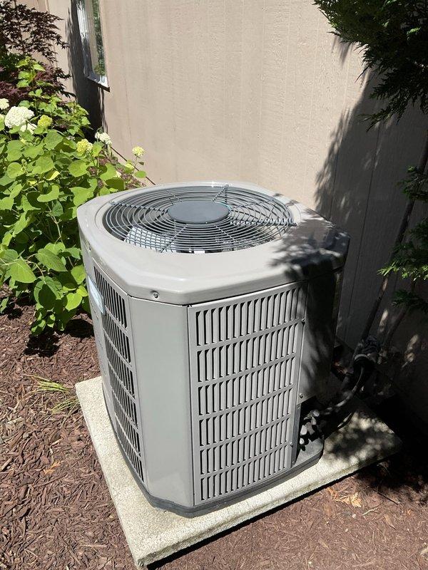 Completed comprehensive BFMA tune-up on residential air conditioning system, including inspection of outdoor condenser unit and indoor air handling components. Evaluated 8-year-old equipment for operational efficiency, verified proper airflow through system, and assessed air filter condition within the air handler. Condenser unit showed good operating condition with no visible damage, proper clearance from landscaping, and adequate ventilation through side slats and top fan guard.