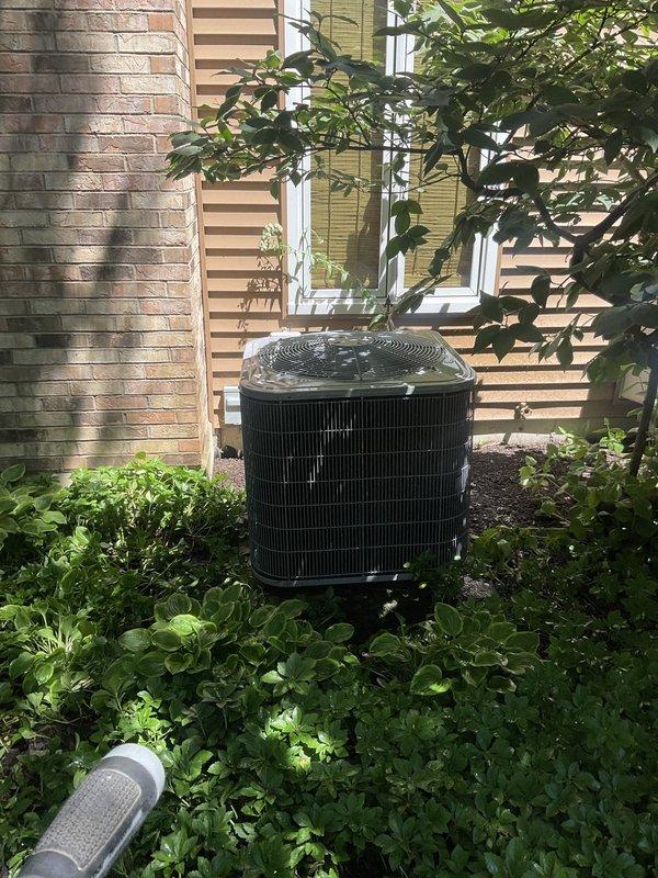 Performed A/C service tune-up and addressed ongoing thermostat issues reported by customer. Inspected air handling unit and verified proper installation of four pleated air filters in V-shaped configuration. Evaluated outdoor condensing unit operation and confirmed proper placement on concrete pad with adequate clearance from surrounding vegetation. Troubleshot thermostat concerns to determine if related to previous service work.