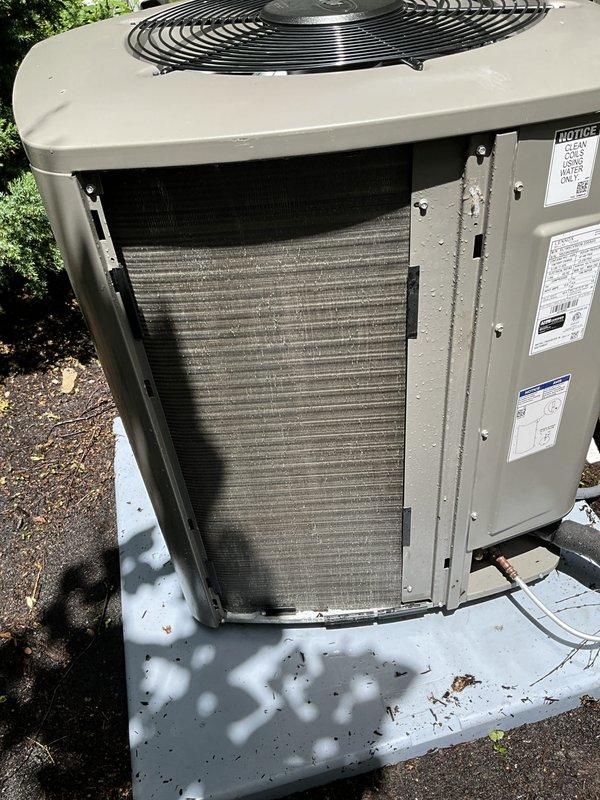 Completed comprehensive BFMA tune-up service on residential air conditioning system. Performed thorough inspection of outdoor condensing unit, accessed internal components through service panel, and evaluated condenser coil condition which showed moderate dust and debris accumulation on aluminum fins. Verified proper installation on concrete pad, inspected refrigerant line connections, confirmed fan guard integrity, and documented equipment condition with photographic records for maintenance history.