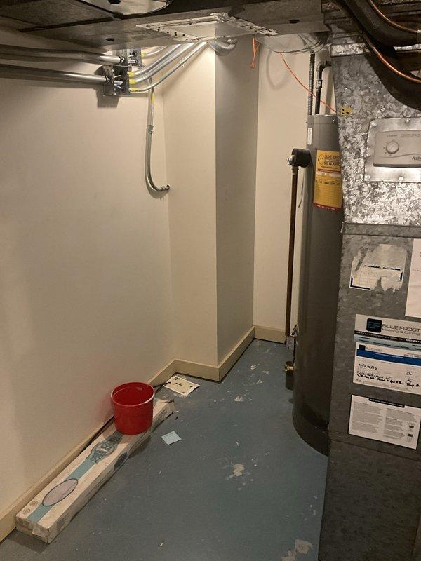 Completed installation of 75-gallon tanked water heater in basement utility area. Initial unit was damaged at the top upon delivery and required return to Ferguson for replacement. Successfully installed replacement unit with proper copper piping connections, secured all water supply lines, and verified system operation with no leaks detected.