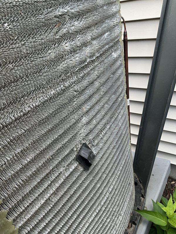 Completed comprehensive BFMA air conditioning tune-up on 3-year-old outdoor condensing unit. Performed standard maintenance protocol including inspection of condenser coil fins which showed moderate dirt accumulation and mineral deposits, cleaned heat exchanger surfaces, checked refrigerant levels, tested electrical connections, and verified proper system operation. Documented equipment condition with photos showing flexible ductwork connection and exterior components in serviceable condition.