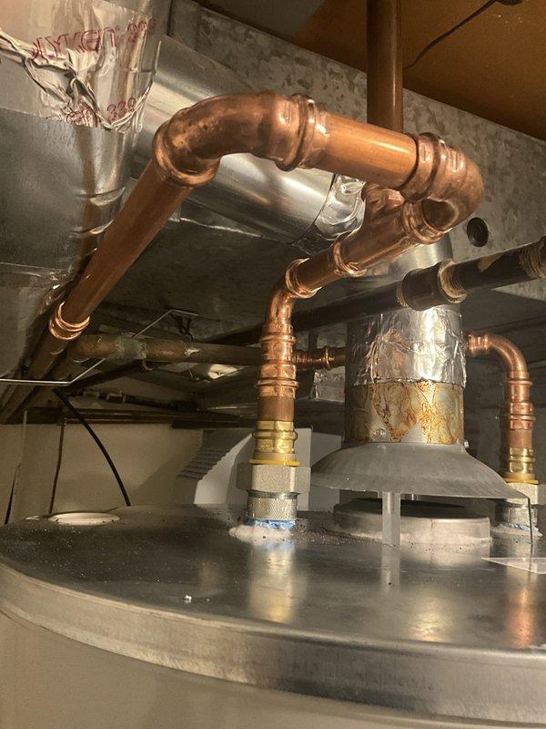 Responded to residential service call for tanked water heater with non-functioning pilot light. Upon arrival, performed diagnostic inspection of 6-year-old gas water heater unit. Examined thermocouple, gas control valve, and pilot assembly for proper operation. Inspected copper supply lines, pressure relief valve, and all plumbing connections for integrity and compliance. Verified gas supply line operation and cleared any obstructions from pilot orifice. Successfully relit pilot light and confirmed stable flame and proper thermocouple function. Tested burner ignition sequence and verified water heater returned to normal heating operation. All connections and safety devices confirmed operational before completing service.