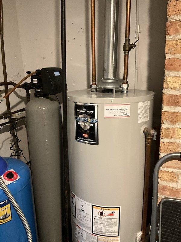Responded to service call for unusual noise coming from 5-year-old Bradford White 40-gallon natural gas water heater. Upon inspection, performed diagnostic assessment of unit including examination of burner assembly, gas valve operation, and sediment accumulation in tank. Identified noise source as sediment buildup on tank bottom causing popping and rumbling sounds during heating cycles. Verified all safety controls, temperature and pressure relief valve, gas connections, and venting system were functioning properly with no leaks detected. Documented unit specifications and current operating condition with photos. Recommended tank flushing procedure to remove mineral deposits and restore quiet operation, with ongoing maintenance schedule to prevent future sediment accumulation.