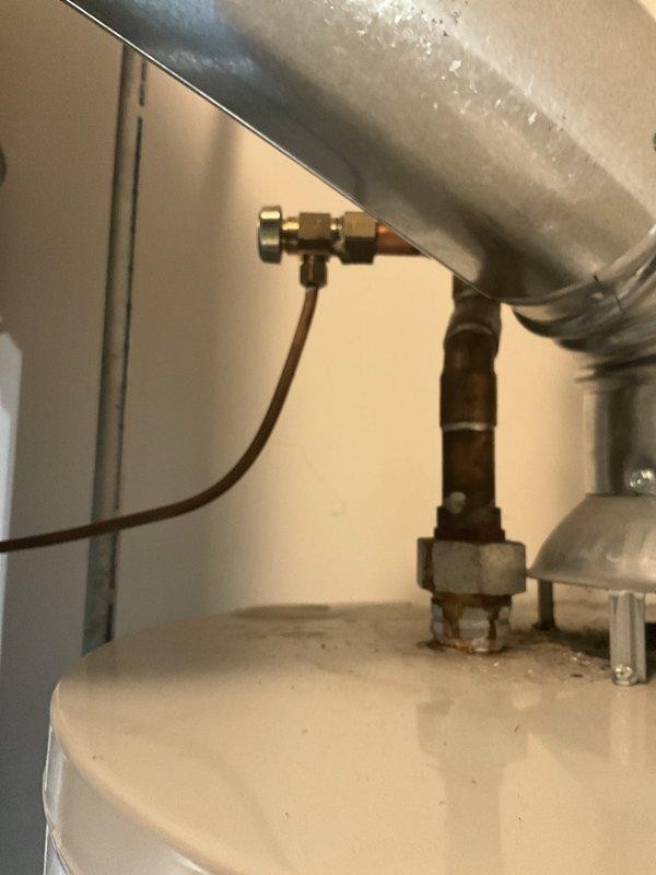 Completed comprehensive plumbing inspection and tune-up maintenance service at residential property. Inspected water heater assembly including pressure relief valve, temperature and pressure gauge reading within normal operating range (0-160 psi scale), brass valve connections, and copper supply line configuration. All plumbing components, fittings, and connections examined and found to be in proper working condition with no visible leaks, corrosion, or safety concerns identified. Documentation photos captured for service records.