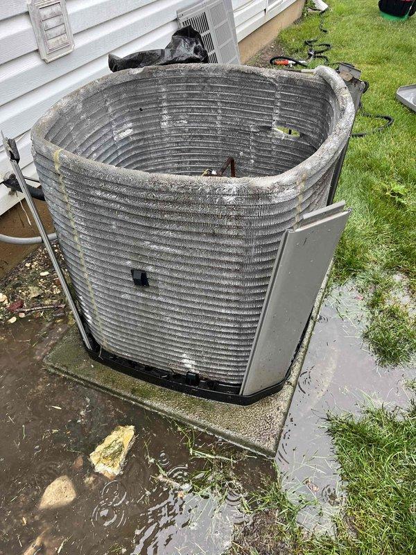 Completed comprehensive BFMA tune-up on 9+ year old HVAC system. Performed standard AC maintenance procedures including inspection of indoor air handler with control board and blower assembly, verified all electrical connections and wiring harnesses were secure. Outdoor condenser unit required extensive attention due to severely deteriorated condition with top cover removed, heavy debris accumulation, and significant biological growth on condenser coil. Addressed standing water issue around concrete pad and cleaned accessible components. Provided homeowner instruction on proper air filter replacement procedures and demonstrated correct filter changing technique. System evaluated for age-appropriate wear and operational concerns documented for future reference.