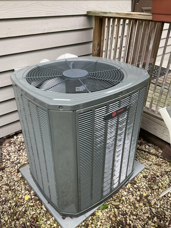 Completed comprehensive BFMA tune-up on 8-year-old residential air conditioning system. Removed protective grille from outdoor condenser unit to access and inspect internal coil assembly, noting dust and debris accumulation on horizontal fins and top rim. Performed standard maintenance procedures including coil cleaning, system performance verification, and reinstallation of protective housing to ensure optimal cooling efficiency for the upcoming season.