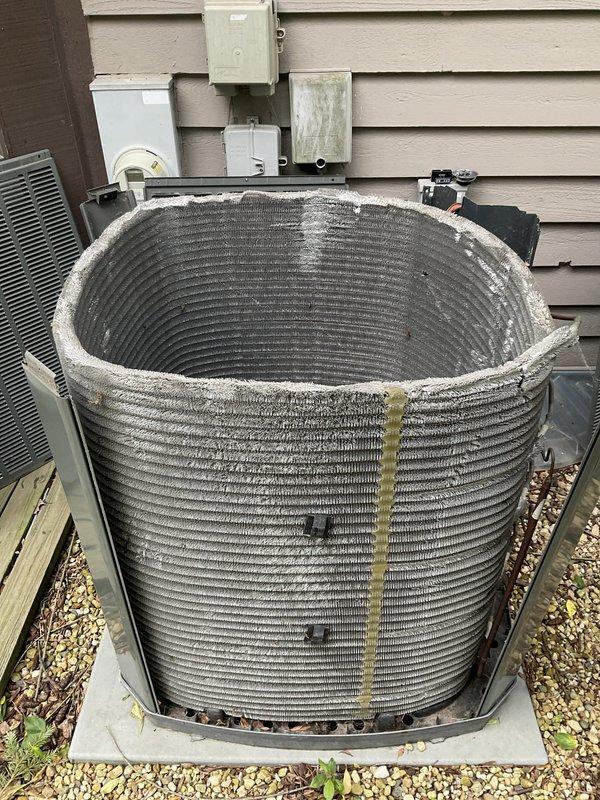 Completed comprehensive BFMA tune-up on 8-year-old residential air conditioning system. Removed protective grille from outdoor condenser unit to access and inspect internal coil assembly, noting dust and debris accumulation on horizontal fins and top rim. Performed standard maintenance procedures including coil cleaning, system performance verification, and reinstallation of protective housing to ensure optimal cooling efficiency for the upcoming season.