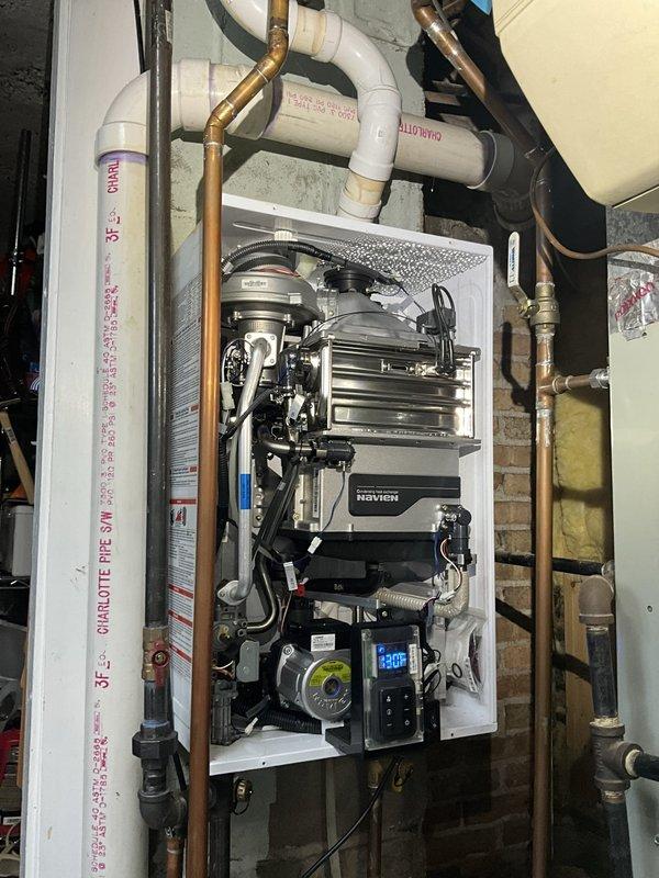 Responded to recurring water leak on 5-year-old Navien tankless water heater unit. Performed comprehensive inspection of heat exchanger, circulation pump connections, PVC condensate drain lines, and copper supply/return piping. Identified source of leak at previous repair location, tightened all plumbing connections, inspected internal components including blower assembly and control module for moisture damage, verified proper operation of pressure relief valve and isolation valves. System tested at operating temperature, confirmed no active leaks present, unit functioning within normal parameters.