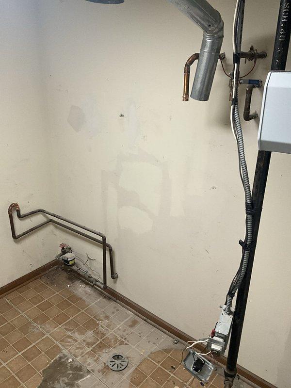 Shut off main water supply and drained entire plumbing system to prepare work area. Removed existing water softener from utility room and installed new 3-valve bypass assembly with proper copper connections. Drained and disconnected existing tanked water heater, then relocated both units to garage for temporary storage during flooring replacement. Upon completion of new tile flooring installation, returned to site and reinstalled water heater with all supply lines, pressure relief valve, and drain connections. Reinstalled water softener with bypass system and verified proper valve operation. Restored water supply to home and tested both units for leaks, proper water flow, and operational functionality. All connections secured and system returned to full service with 1-year labor warranty provided.