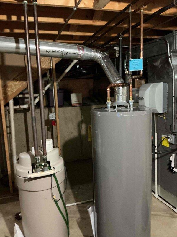 Completed comprehensive BFMA tune-up on one-year-old air conditioning system per membership agreement. Customer reported thermostat set to 70 degrees but indoor temperature remaining at 77 degrees, indicating insufficient cooling capacity. Performed standard maintenance protocol including inspection of outdoor condenser unit, verified refrigerant levels, checked electrical connections, cleaned condenser coils, and assessed airflow at indoor air handler located in basement utility area. Identified and addressed performance issue preventing system from reaching desired temperature setpoint. System tested and verified operational upon completion of tune-up service.