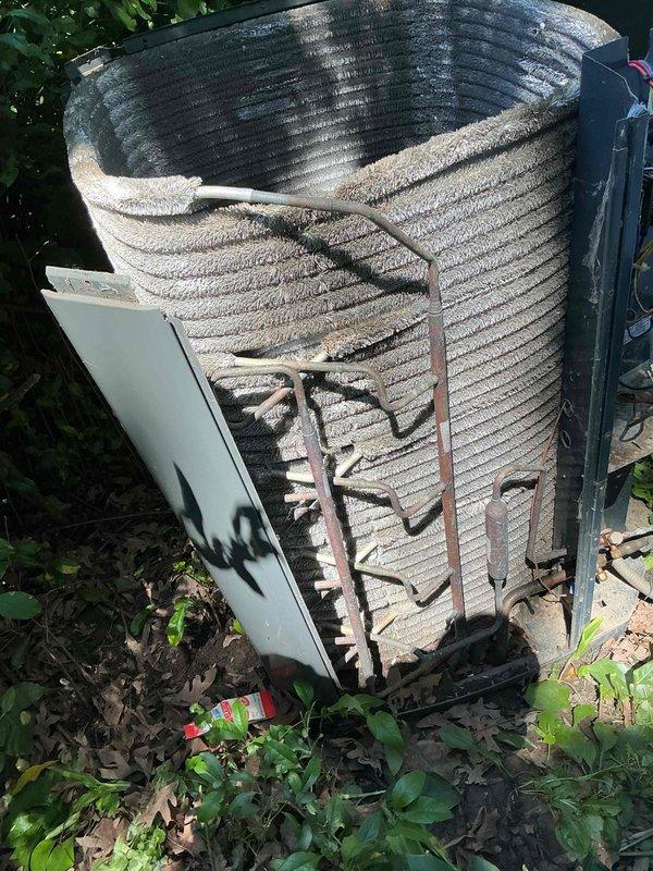 Completed comprehensive BFMA tune-up on 14-year-old air conditioning system. Inspected and tested electrical components including contactor with multiple wire connections showing age-related discoloration; all terminals secured and functional. Outdoor condenser unit required extensive cleaning due to heavy accumulation of dirt, debris, and organic material on coil fins and protective casing; removed buildup to restore proper airflow and heat transfer efficiency. Addressed damaged exterior panel and assessed overall system condition, noting corrosion on mounting hardware and framework consistent with equipment age and outdoor exposure.