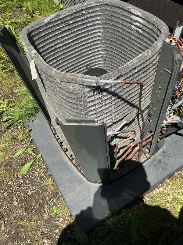 Completed comprehensive BFMA tune-up service on two air conditioning systems, both over four years old. Performed standard maintenance protocol including inspection of outdoor condenser unit, which revealed corrosion and rust damage on lower right section of coil fins requiring monitoring. Inspected indoor air handling components in attic space, examined ductwork insulation and mechanical connections. Documented equipment condition with photographs showing coil deterioration on exterior unit and verified proper installation of system components. All accessible areas were inspected and routine maintenance procedures completed per BFMA specifications.