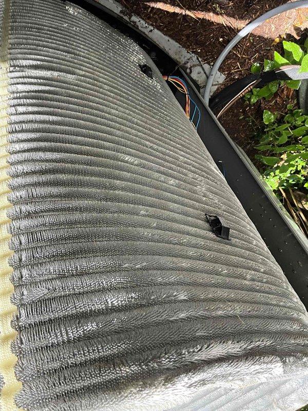 Completed comprehensive BFMA tune-up service on a 2+ year old outdoor air conditioning system. Performed full system inspection, cleaned condenser coils showing dirt accumulation and discoloration, checked refrigerant lines and electrical connections, verified proper operation of all components, and ensured unit was running at optimal efficiency. System is operating within normal parameters following maintenance completion.