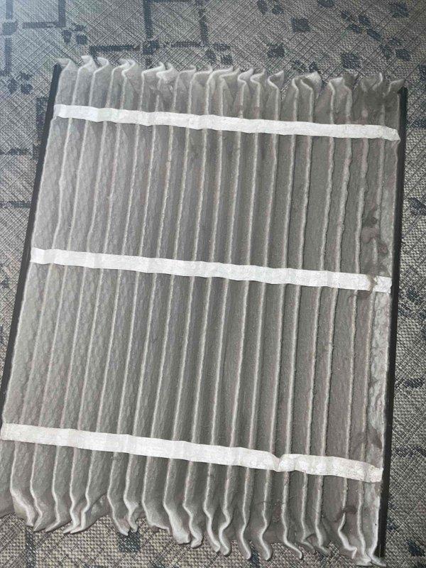 Completed comprehensive BFMA tune-up on 4-year-old air conditioning system, including full system inspection, performance testing, and semi-annual filter replacement. Replaced heavily soiled pleated air filter that showed significant dust and debris accumulation, which was restricting airflow and reducing system efficiency. Inspected outdoor condenser unit coil assembly, noting foam insulation application on cylindrical coil fins with visible environmental debris accumulation between fin spacing, though unit remains operational within acceptable parameters.