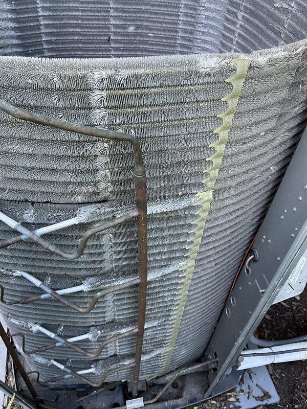 Completed comprehensive BFMA tune-up on 4-year-old air conditioning system, including full system inspection, performance testing, and semi-annual filter replacement. Replaced heavily soiled pleated air filter that showed significant dust and debris accumulation, which was restricting airflow and reducing system efficiency. Inspected outdoor condenser unit coil assembly, noting foam insulation application on cylindrical coil fins with visible environmental debris accumulation between fin spacing, though unit remains operational within acceptable parameters.