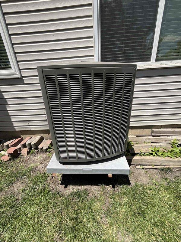 Responded to emergency call for 2-year-old residential AC condenser unit with shifted base creating safety hazard. Upon arrival, confirmed condenser pad had settled unevenly, causing unit to lean and creating risk of equipment damage or failure. Used level to assess degree of displacement and verify pad stabilization requirements. Repositioned and leveled condenser unit on existing concrete pad with proper foundation support to restore safe operating position. Verified unit stability and proper alignment to manufacturer specifications. Customer advised that no active warranty coverage exists due to missed maintenance requirements.