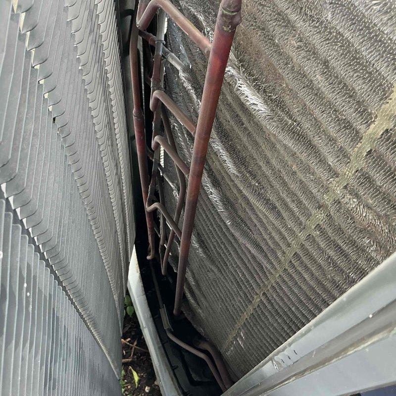 Completed comprehensive BFMA tune-up on Carrier split-system air conditioning unit. Performed full system inspection including condenser coil examination, refrigerant line assessment, electrical component testing, and interior wiring verification. Noted minor debris accumulation at base of outdoor unit and surface oxidation on copper refrigerant lines; condenser coil fins found in good operational condition with all electrical connections secure and properly terminated.