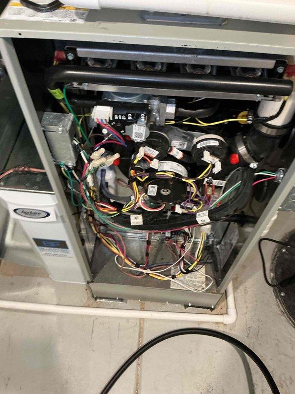 Completed comprehensive BFMA tune-up on Carrier split-system air conditioning unit. Performed full system inspection including condenser coil examination, refrigerant line assessment, electrical component testing, and interior wiring verification. Noted minor debris accumulation at base of outdoor unit and surface oxidation on copper refrigerant lines; condenser coil fins found in good operational condition with all electrical connections secure and properly terminated.