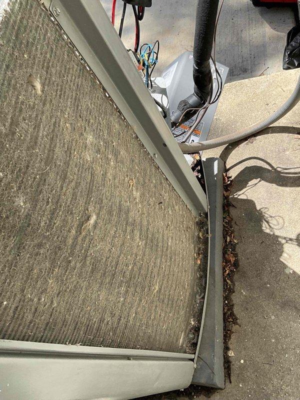 Completed comprehensive BFMA tune-up on 9+ year old outdoor AC unit. Upon arrival, found significant accumulation of leaves, twigs, and organic debris along top panel seams and heavily soiled evaporator coil with thick layer of gray-brown dust and debris buildup. Removed front access panel to expose internal components, cleared exterior debris from unit housing, and cleaned condenser coils. Inspected electrical connections, capacitor, and refrigerant lines for proper operation. Verified all mechanical and electrical components functioning within manufacturer specifications following cleaning and maintenance procedures.