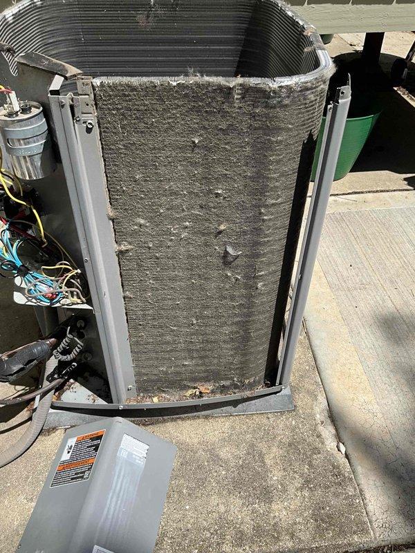 Completed comprehensive BFMA tune-up on 9+ year old outdoor AC unit. Upon arrival, found significant accumulation of leaves, twigs, and organic debris along top panel seams and heavily soiled evaporator coil with thick layer of gray-brown dust and debris buildup. Removed front access panel to expose internal components, cleared exterior debris from unit housing, and cleaned condenser coils. Inspected electrical connections, capacitor, and refrigerant lines for proper operation. Verified all mechanical and electrical components functioning within manufacturer specifications following cleaning and maintenance procedures.