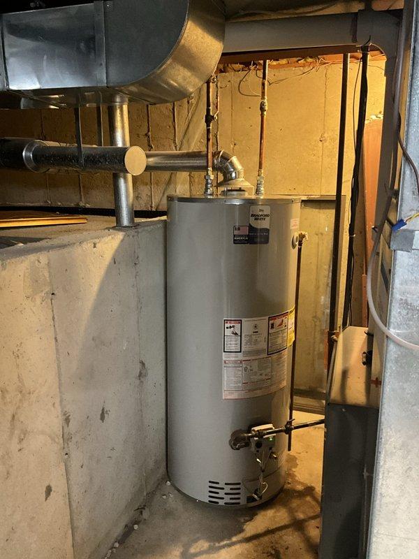 Removed and properly disposed of existing water heater from basement location. Installed new 75-gallon natural gas Bradford White water heater with 6-year tank warranty and 1-year labor warranty. Modified and connected flue ventilation system, natural gas supply line, and hot and cold water lines using copper piping and brass fittings to ensure proper operation and code compliance.