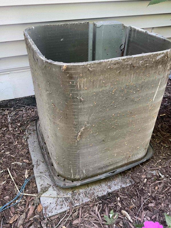 Completed comprehensive BFMA tune-up service on a 3-year-old outdoor condensing unit. Upon arrival, noted significant accumulation of environmental debris, algae, and grime on exterior panels and coil surfaces. Performed thorough cleaning of condenser coils, removed organic growth and buildup from housing, cleared surrounding area of leaves and debris, inspected fan assembly and electrical connections, verified proper refrigerant levels, tested system operation, and confirmed unit is functioning within manufacturer specifications.