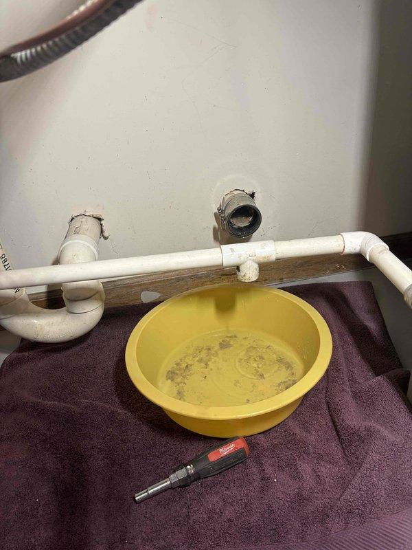 Responded to clogged floor drain service call. Upon arrival, accessed the drain plumbing beneath the fixture and removed the trap assembly to investigate the blockage. Inspection revealed significant mineral scale buildup and sediment accumulation inside the copper pipe fittings, which was restricting water flow and causing the drainage issue. Disassembled the affected plumbing components, cleared the blockage, and flushed the line to restore proper drainage. Reassembled all connections and verified system was draining freely with no leaks.
