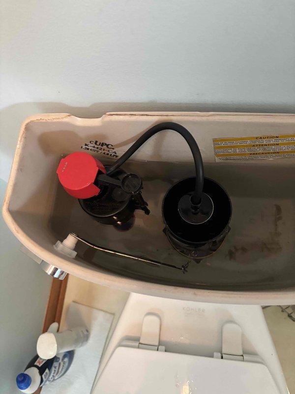 Responded to service call for master bathroom toilet requiring internal component replacement. Upon inspection, identified worn fill valve assembly and deteriorating flush valve components causing inefficient water flow and potential running water issues. Removed existing fill valve mechanism and flush ring assembly from toilet tank. Installed new fill valve with improved water flow regulation and installed new flush ring assembly with updated flapper mechanism to ensure proper seal and water conservation. Replaced corroded flexible water supply line connecting wall shut-off valve to toilet tank inlet with new braided stainless steel supply line, providing improved durability and leak resistance. Tested all connections for proper seal integrity and verified no water leaks at supply line connections or internal tank components. Cycled flush mechanism multiple times to confirm proper fill valve operation, appropriate water level setting, and complete flapper seal engagement. Adjusted fil