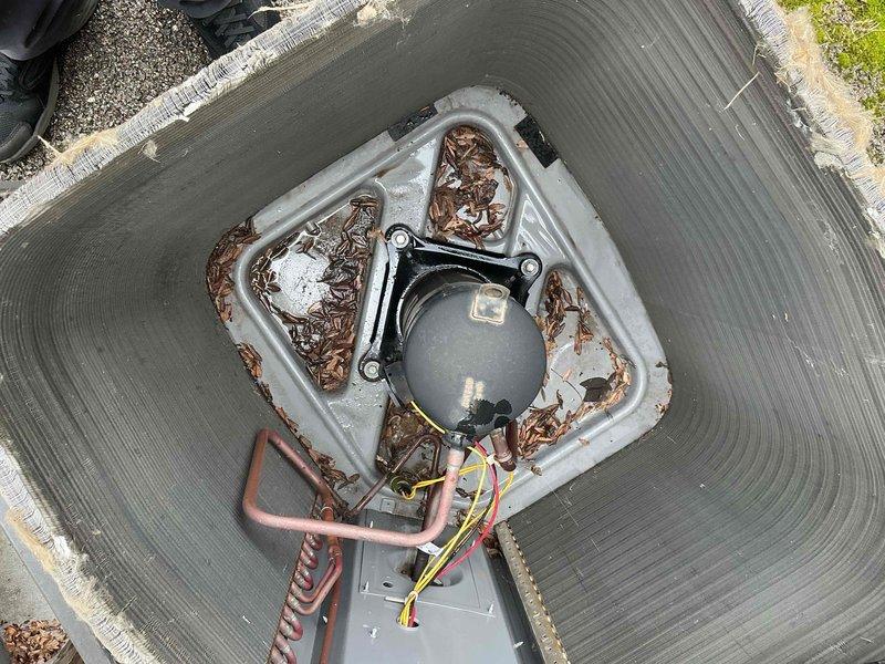 Completed comprehensive BFMA tune-up on 8+ year old air conditioning system, arriving after 11AM per customer preference. Performed full system inspection including electrical control panel examination, verified all wire connections and contactors, inspected outdoor condenser unit, and removed accumulated organic debris (leaves and twigs) from condenser housing and surrounding area. All components tested and operating within normal parameters upon completion.