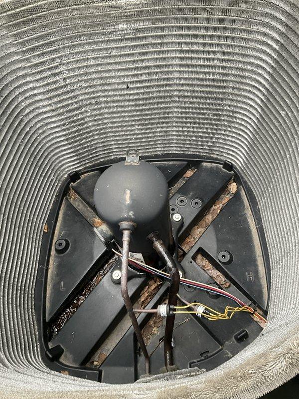 Completed comprehensive BFMA tune-up service on residential air conditioning system aged 9+ years. Outdoor condenser unit exhibited heavy accumulation of lint, dust, and debris throughout coil surfaces, significantly restricting airflow and reducing system efficiency. Performed thorough cleaning of condenser coils, removing dense matted buildup from fins and cylindrical coil structure. Inspected internal components including compressor, fan motor assembly, electrical connections, and capacitor. Verified proper operation of all electrical wiring and connections. System restored to optimal operating condition with improved airflow and heat transfer capability.