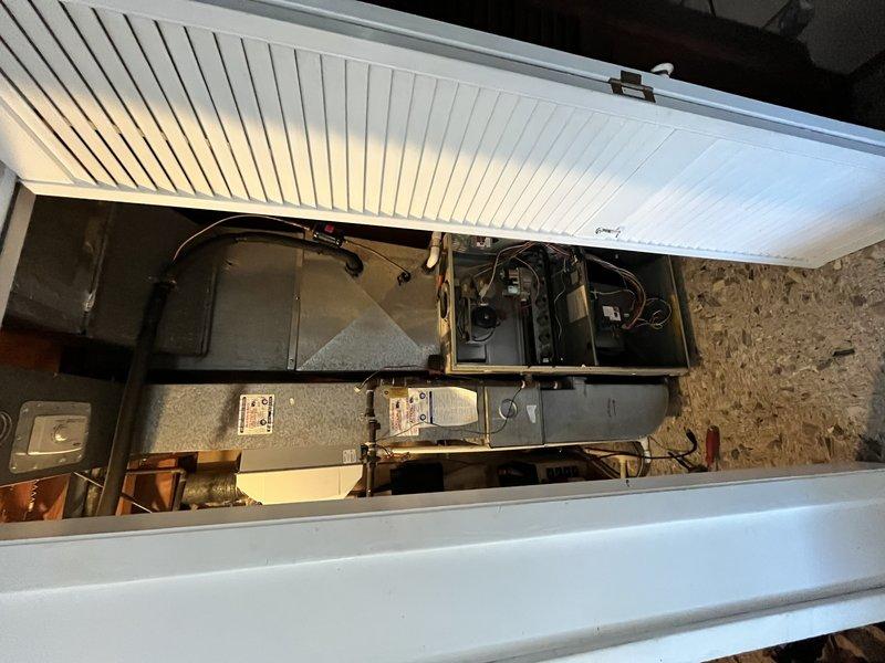 Completed full HVAC system installation including Lennox SL280UH070BK 80% AFUE two-stage variable speed furnace and ML13KC1-036 13 SEER air conditioning unit in basement utility area. Installed ADP cased evaporator coil from Munch Supply, connected refrigerant lines, and integrated system with existing humidifier and thermostat. Configured ductwork connections to new air handler, verified all electrical connections, tested two-stage heating operation and variable speed blower functionality, and confirmed proper airflow throughout system.
