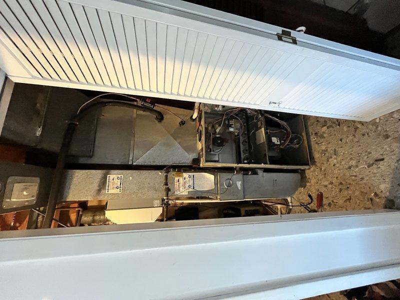 Completed full HVAC system installation including Lennox SL280UH070BK 80% AFUE two-stage variable speed furnace and ML13KC1-036 13 SEER air conditioning unit in basement utility area. Installed ADP cased evaporator coil from Munch Supply, connected refrigerant lines, and integrated system with existing humidifier and thermostat. Configured ductwork connections to new air handler, verified all electrical connections, tested two-stage heating operation and variable speed blower functionality, and confirmed proper airflow throughout system.