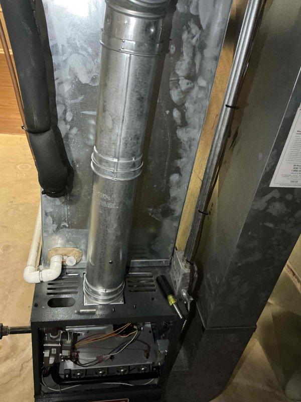 Performed comprehensive evaluation of second-floor HVAC system with basement-located equipment for full system replacement estimate. Assessed existing furnace/air handler unit experiencing air conditioning performance issues with diminished cooling capacity. Documented current installation including galvanized ductwork, electrical panel circuit configuration for multiple AC zones, condensate drainage system, and control board wiring. Provided equipment replacement options for both air conditioning upgrade and complete HVAC system replacement to address operational deficiencies and improve home comfort performance.